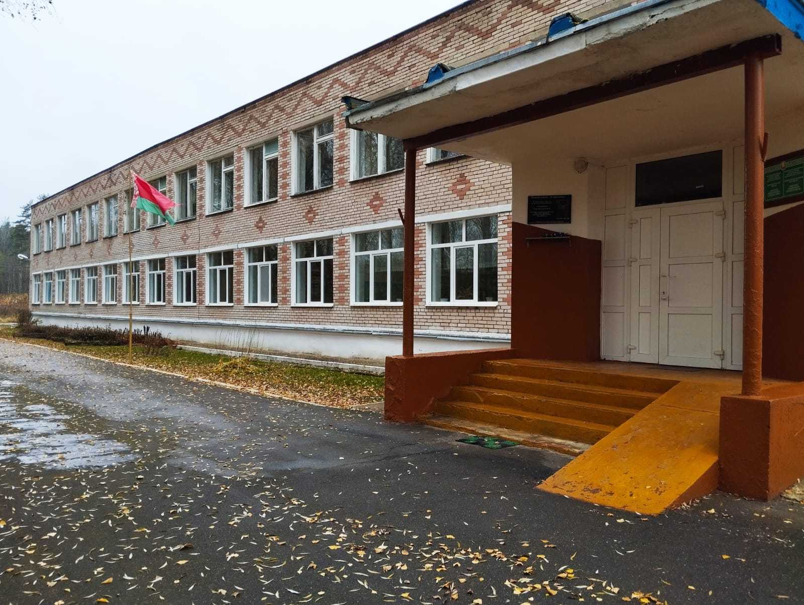 A complex of buildings containing a school, garage, vegetable storage facility, boiler room, and warehouse